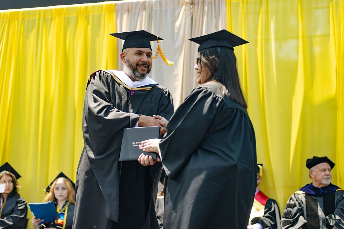 DiplomaFemale-min Rio hondo college board of trustee Oscar Valladares handling diploma to graduating student